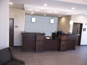a lobby with a reception desk in a office at Quality Inn & Suites Victoria East in Victoria
