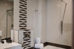 a bathroom with a shower and a toilet and a sink at Signa Juristas in Valencia +63 photos