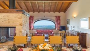 a dining room with a table and chairs and a window at IL CASALE DEL NONNO 8&2 Emma Villas in Guardea