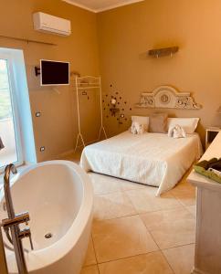 a bathroom with a bed and a tub and a sink at Il Panorama Housing Cilento in Santa Maria di Castellabate