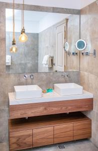 a bathroom with two sinks and a mirror at Heritage Villa Nobile in Dubrovnik