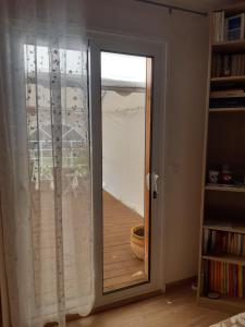a sliding glass door with a view of a balcony at Le bois bouquet in Saint-Cézaire-sur-Siagne