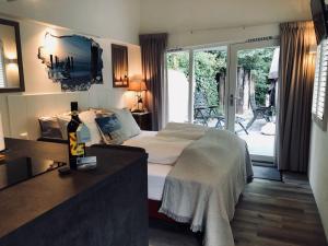a bedroom with a bed and a sliding glass door at Tussenrenesseenstrand in Renesse