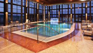 a large swimming pool in a building with windows at Isleta Resort & Casino in Albuquerque