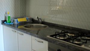 a kitchen counter with a sink and a stove at Apartment Zmisa in Stara Novalja +32 photos
