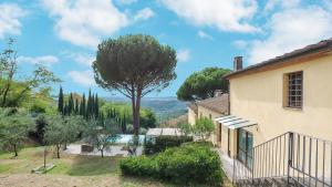 a house with a tree and a swimming pool at OTTOPINI 8, Emma Villas in Montecatini Terme