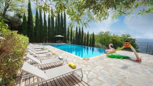 a swimming pool with lounge chairs and a pool slide at OTTOPINI 8, Emma Villas in Montecatini Terme
