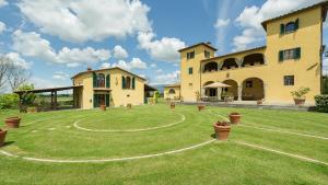 a large house with a large lawn in front of it at Poggerello 18, Emma Villas in Laterina
