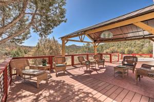 a patio with chairs and tables on a deck at Stunning West Sedona Retreat Deck and Soaking Tubs! in Sedona