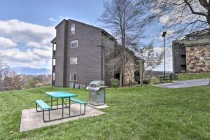 a picnic table and a grill in front of a barn at Pristine Gatlinburg Resort Condo with Mountain Views in Gatlinburg