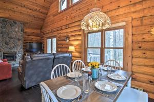 a dining room with a table and a chandelier at Secluded Gaylord Cabin with Deck, Fire Pit and Grill! in Gaylord