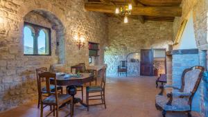 a dining room with a table and chairs in a building at SANTA ILLUMINATA 20, Emma Villas in Massa Martana