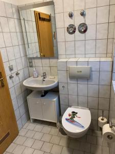 a bathroom with a toilet and a sink at VormHolte2 in Radevormwald