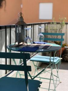 a table with a lamp and two chairs on a patio at Ca' Adriana in Lido di Jesolo