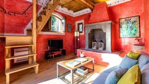 a living room with red walls and a fireplace at TORRE ANGELINA 10&2, Emma Villas in Montecatini Terme