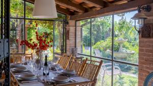 a dining room with a table and a large window at Villa Agave 8, Emma Villas in Monteciccardo