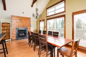 a dining room with a table and chairs and a fireplace at Blue View 4 Vega Chalet 84147 in Blue Mountains