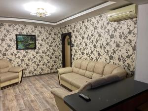 a waiting room with a couch and a table at Ugra apartment 36 in Kogalym