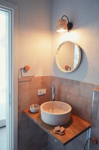 a bathroom with a sink and a mirror at Rijeka Alaçatı in Cesme