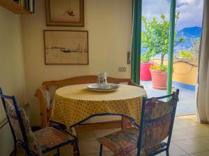 a table and chairs with a table and a window at Casa Sardi in Brenzone sul Garda