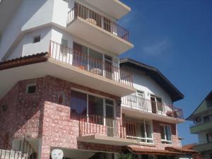 a tall building with balconies on the side of it at Guest House Bogat-Beden in Ravda