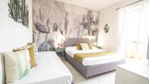 Postel nebo postele na pokoji v ubytování Hotel Il Perseo