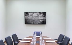 a conference room with a long table and chairs at PortoBay Liberdade in Lisbon +40 photos