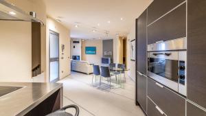 a kitchen and living room with a stove and a table at VILLA ELDA 6, Emma Villas in Loano