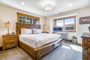 a bedroom with a bed and a desk and a window at Tranquility Trail at Suncadia Resort in Cle Elum