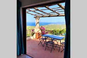 a view from the balcony of a house with a table and chairs at Sunrise 23 in San Pantaleo