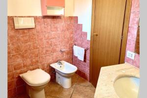 a bathroom with a toilet and a sink at Sunrise 23 in San Pantaleo +21 photos