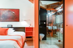 a bedroom with a bed and a glass shower at Teritoria Château de Besseuil in Clessé