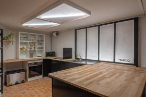 a kitchen with a sink and a large window at Naéco Le Pouldu in Clohars-Carnoët