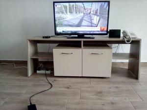 a desk with a computer monitor on top of it at Silver Beach A98 in Byala