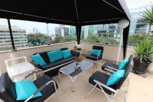 a balcony with a couch and chairs and a table at Hotel Boulevard in Lima