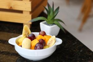 a bowl of fruit on a counter with a potted plant at Hotel Boulevard in Lima