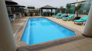 a swimming pool with blue water in a hotel at Hotel Boulevard in Lima