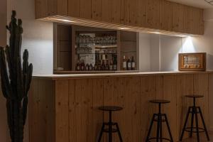a bar with three bar stools in a room at Naéco Le Pouldu in Clohars-Carnoët +52 photos