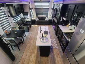 an aerial view of a living room and kitchen in an rv at Grand Canyon RV Glamping in Williams