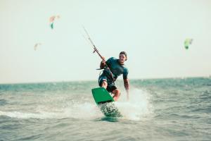 a man on a surfboard in the water at Haus Klaarstrand in Wenningstedt +40 photos