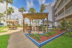 a patio with a wooden pergola and tables at Pool and Direct Beach Access Corpus Christi Escape in Corpus Christi
