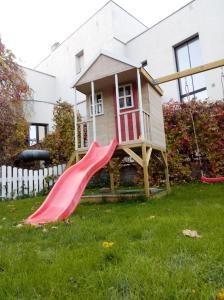 a play house with a slide in the yard at Kotka Housing in Pärnu