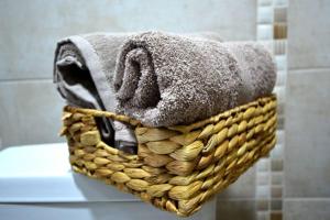 a basket filled with towels on top of a toilet at View Apartments Belasica in Mokrievo