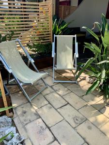 a chair and a mirror sitting on a patio at La Dimora in riva al mare in Vieste