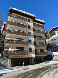 a building with balconies on the side of a street at Sonnalpine Apt 12 - Managed by TheSelectionist in St. Moritz