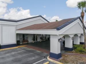 
a large white building with a white roof at Stayable Suites Florida Mall Orlando in Orlando
