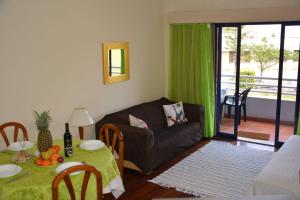 a living room with a couch and a table at Your Home In Madeira III in Funchal