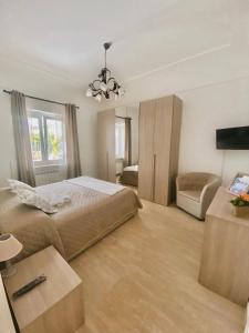 a bedroom with a large bed and a chandelier at La Primavera in Anacapri