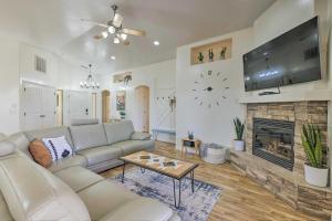 a living room with a couch and a fireplace at Modern Retreat with View, 9 Mi to Wahweap Beach! in Page