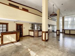a large room with a pillar and a kitchen in it at Stayable Orlando at Florida Mall in Orlando